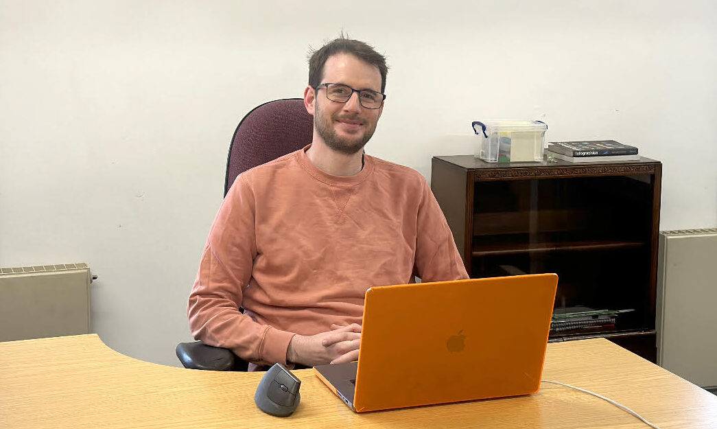 Marc, seated at his desk in the SuSy office
